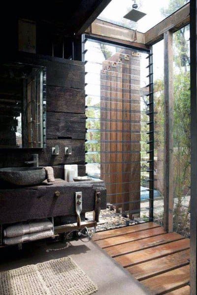 Rustic bathroom with wooden touches and a scenic outdoor view through glass panels