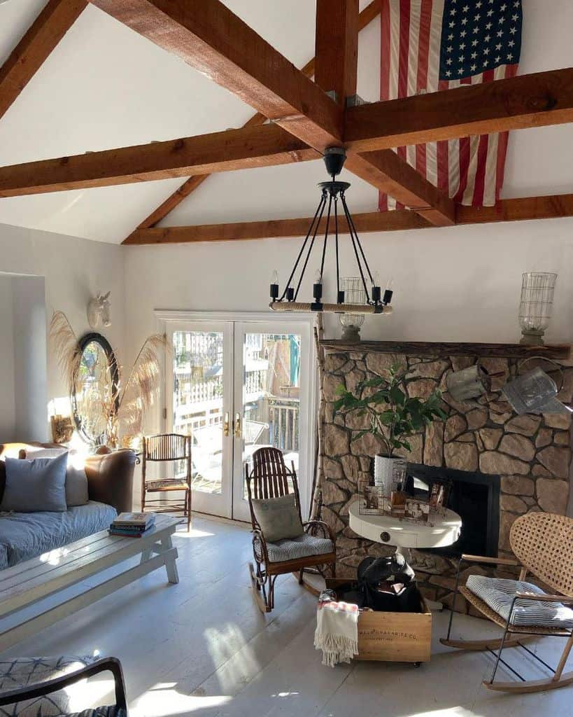exposed wood beams american flag stone fireplace farmhouse living room