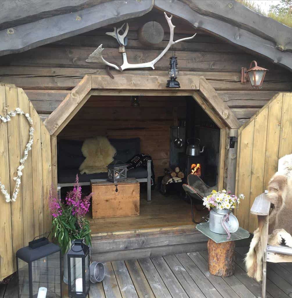 rustic she shed with fireplace and sofa 