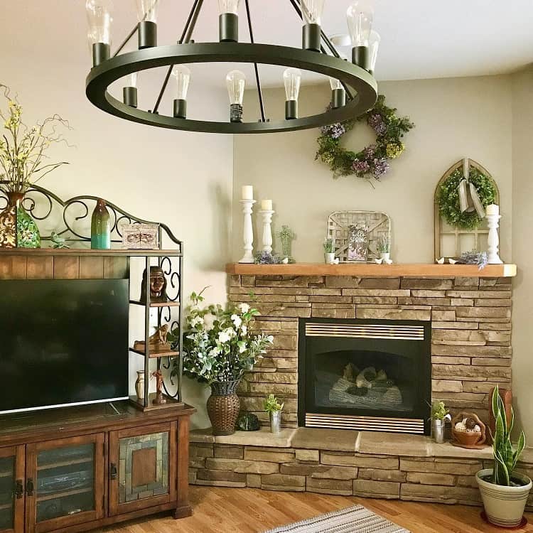rustic stacked stone fireplace wood tv cabinet chandelier