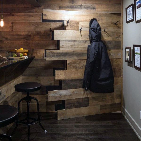 rustic wood panel basement bar hidden door