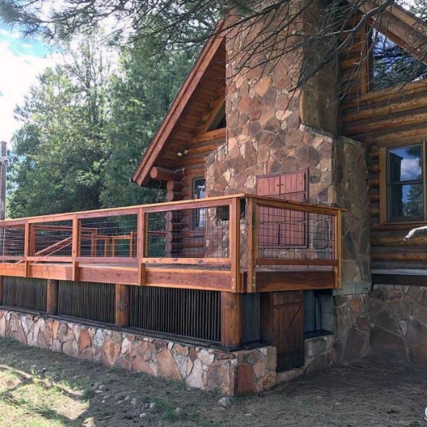 rustic wood deck railing stone house