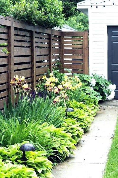 tall rustic wood front yard fence 