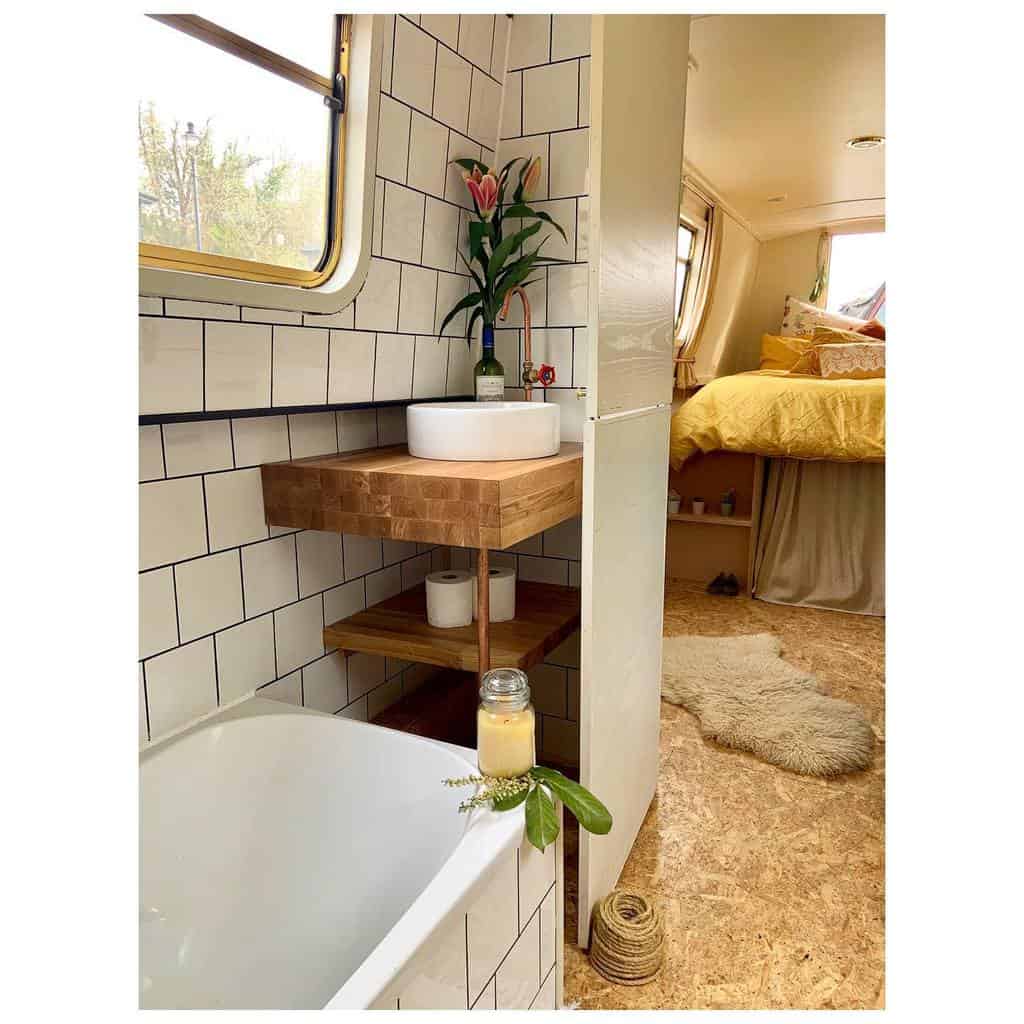 small white tile bathroom in boat