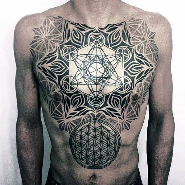 Person with intricate geometric tattoos on chest and abdomen, featuring interlocking patterns and a circular design
