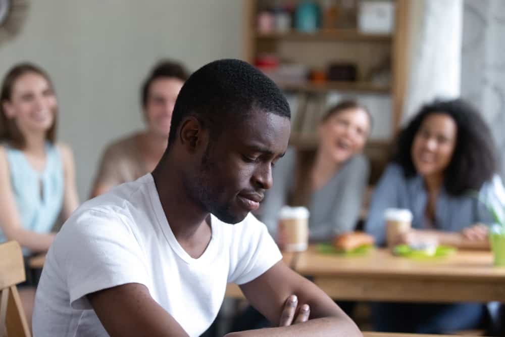 sad african man sitting in cafe
