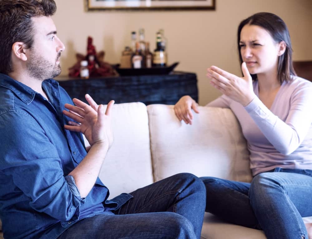 sad couple arguing at home