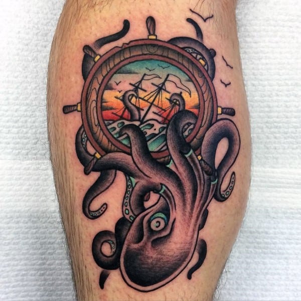 Sailing Ship Inside Wheel With Kraken Guys Leg Calf Tattoos
