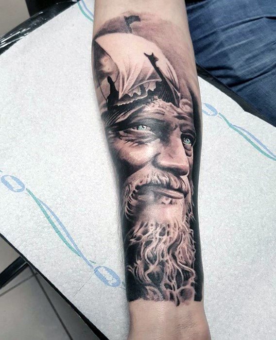 Forearm tattoo of an elderly man with a beard, ship sails, and mountain landscape
