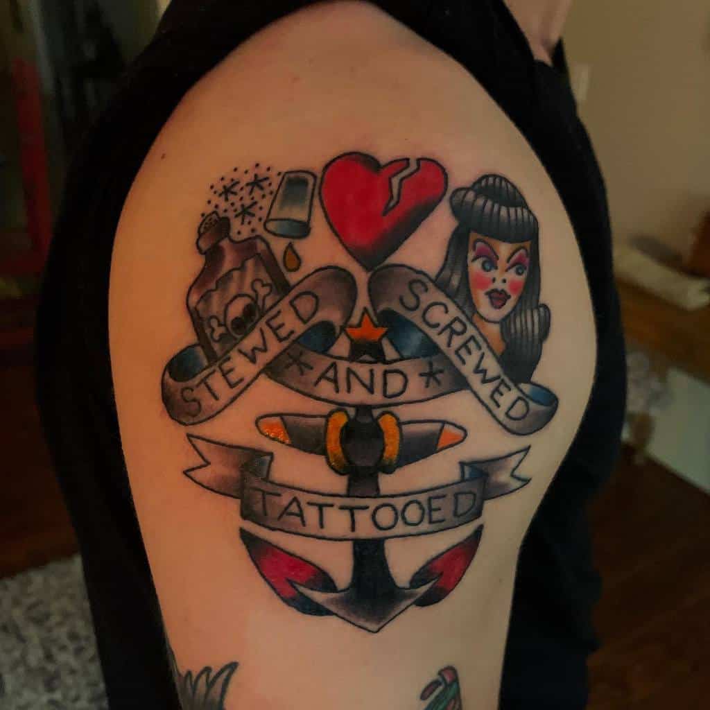 Colorful tattoo on an arm with "Stewed, Screwed and Tattooed" between a heart, woman, and anchor