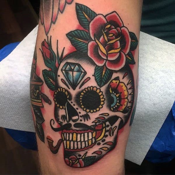 Sailor Jerry Style Creative Mens Sugar Skull Tattoo With Flowers On Inner Bicep Of Arm