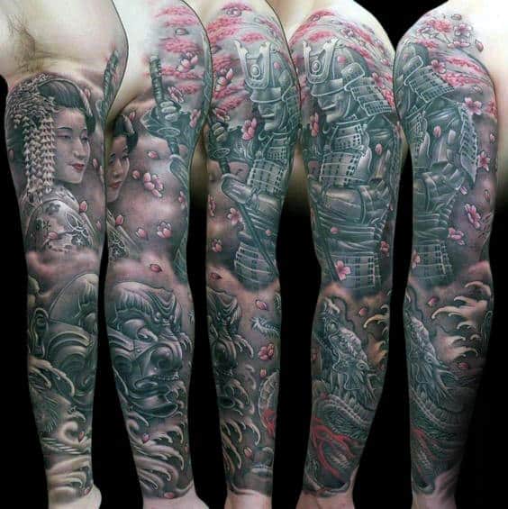 Full sleeve tattoo featuring a samurai warrior, geisha, fierce masks, and cherry blossoms in black and grey with pink highlights for contrast