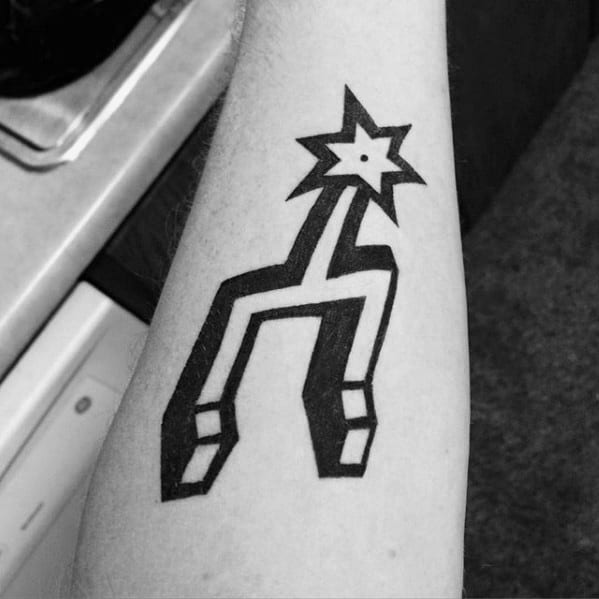 Bold black San Antonio Spurs logo tattoo on forearm, featuring the signature spur design with clean lines and sharp geometric edges.