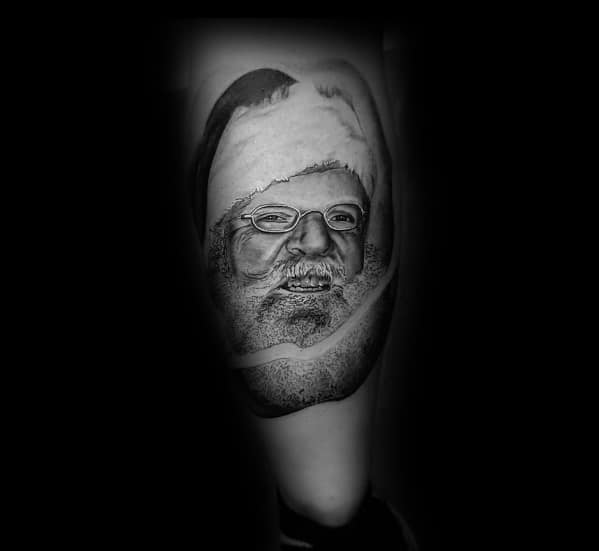 Black and grey realistic Santa Claus tattoo featuring fine shading, expressive eyes, and glasses, creating a detailed and lifelike holiday portrait.