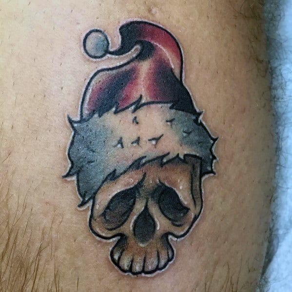 Dark-themed Santa Claus skull tattoo with a tattered hat, bold outlines, and shading, blending holiday spirit with a gothic, edgy aesthetic.