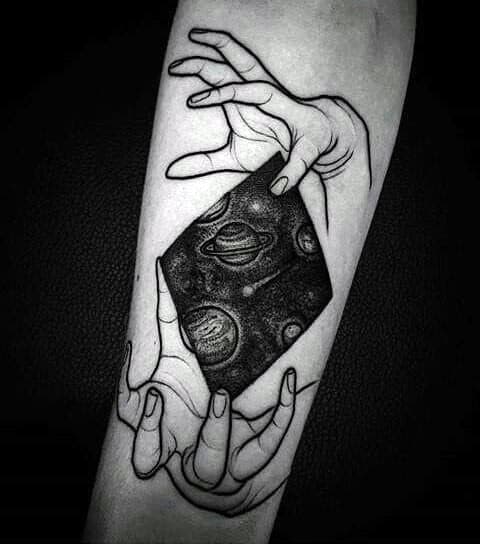 Surreal Saturn tattoo design for men featuring two hands holding a cosmic portal with planets and stars in deep black shading.