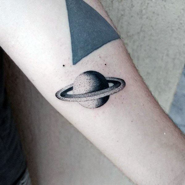 Dotwork Saturn tattoo design for men with smooth shading, precise rings, and minimal black dots surrounding the planet on the forearm.