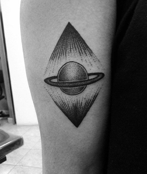 Bold Saturn tattoo design for men within a diamond frame, featuring sharp line bursts and dot shading radiating from the planet’s center.