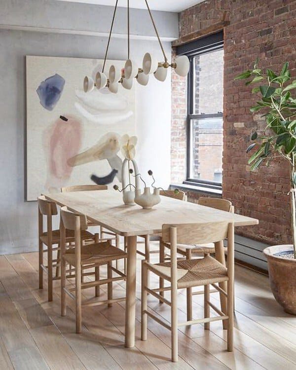 Scandinavian boho dining room with minimalist design, light wood furniture, and modern lighting.