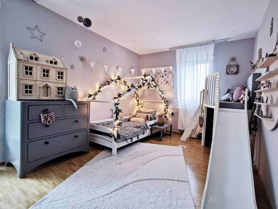 girls bedroom white canopy bed gray cabinets doll house slide