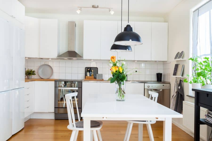 white cabinet kitchen with table and chairs