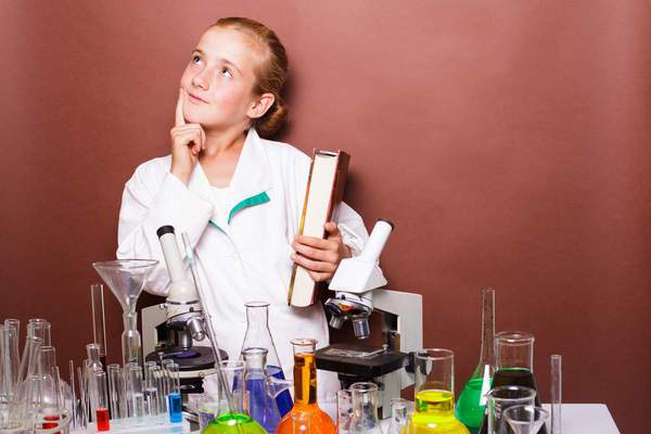 schoolgirl standing near blackboard in the laboratory class