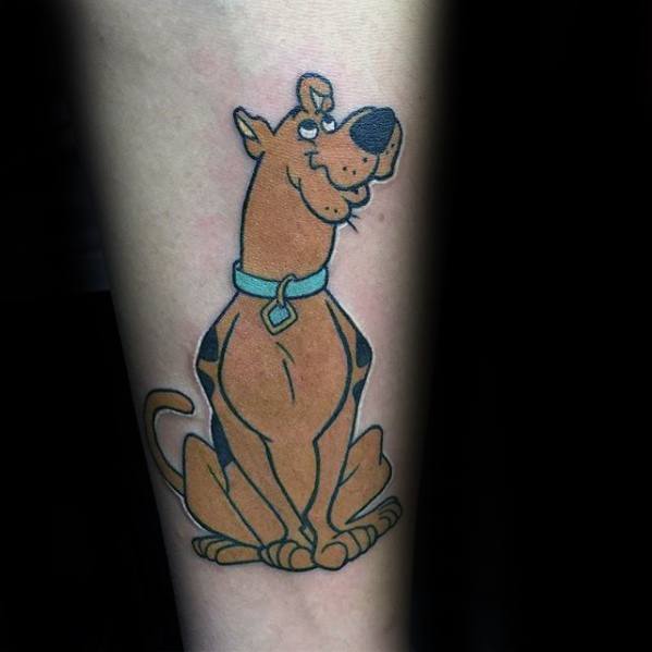 Tattoo of Scooby-Doo sitting proudly with a sly smile, wearing his classic blue collar and diamond-shaped tag.
