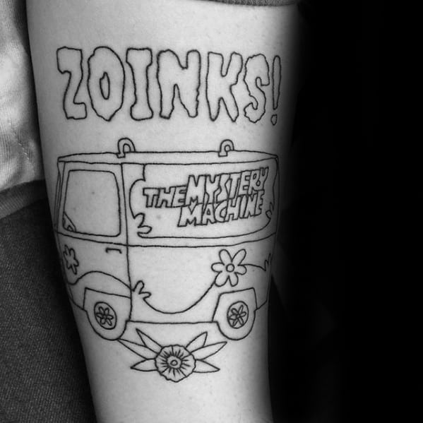 Black and white tattoo of the Mystery Machine with the word “ZOINKS!” above and a flower design below the van.