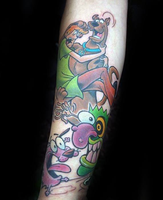 Tattoo of Shaggy hugging Scooby-Doo in fear, with Courage the Cowardly Dog below reacting to a colorful monster in a chaotic scene.