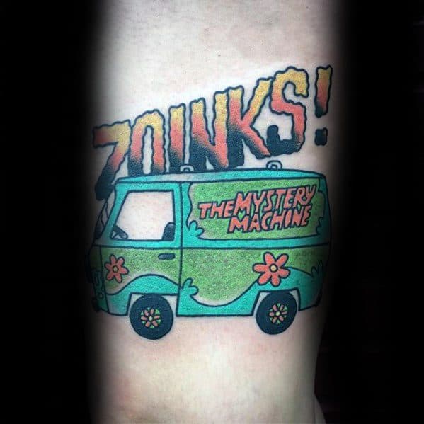 Colorful tattoo of the Mystery Machine with bold “ZOINKS!” text above, featuring vibrant green, blue, and red comic-style shading.