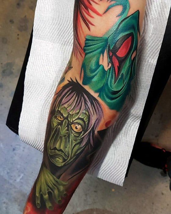 Vibrant tattoo of classic Scooby-Doo villains, featuring the green ghost with red eyes above and the Zombie from “Zombie Island” below.