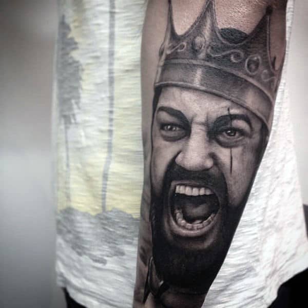 Screaming Man With Crown Tattoo On Arms For Men