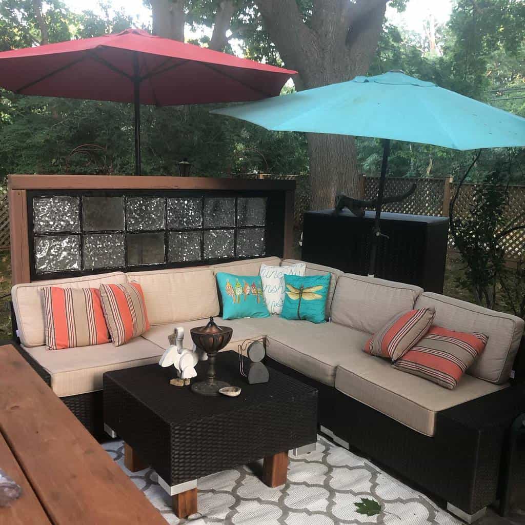 corner patio with l-shape sofa and umbrella shades 