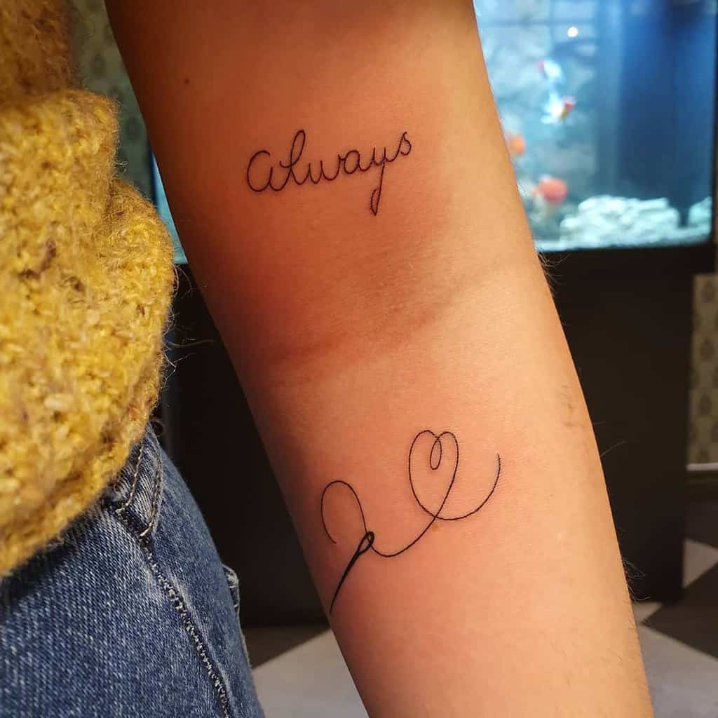Minimalistic forearm tattoo with 'Always' in delicate cursive and a heart-shaped continuous line, symbolizing eternal love