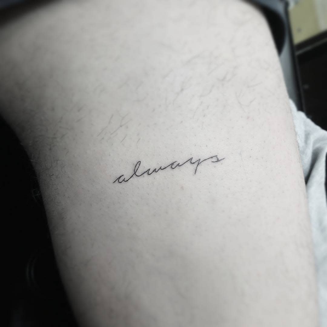 Close-up of a small, cursive tattoo reading "always" on a skin