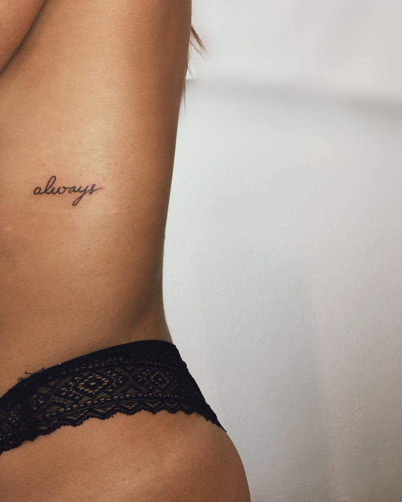 A "always" script tattoo on the side torso