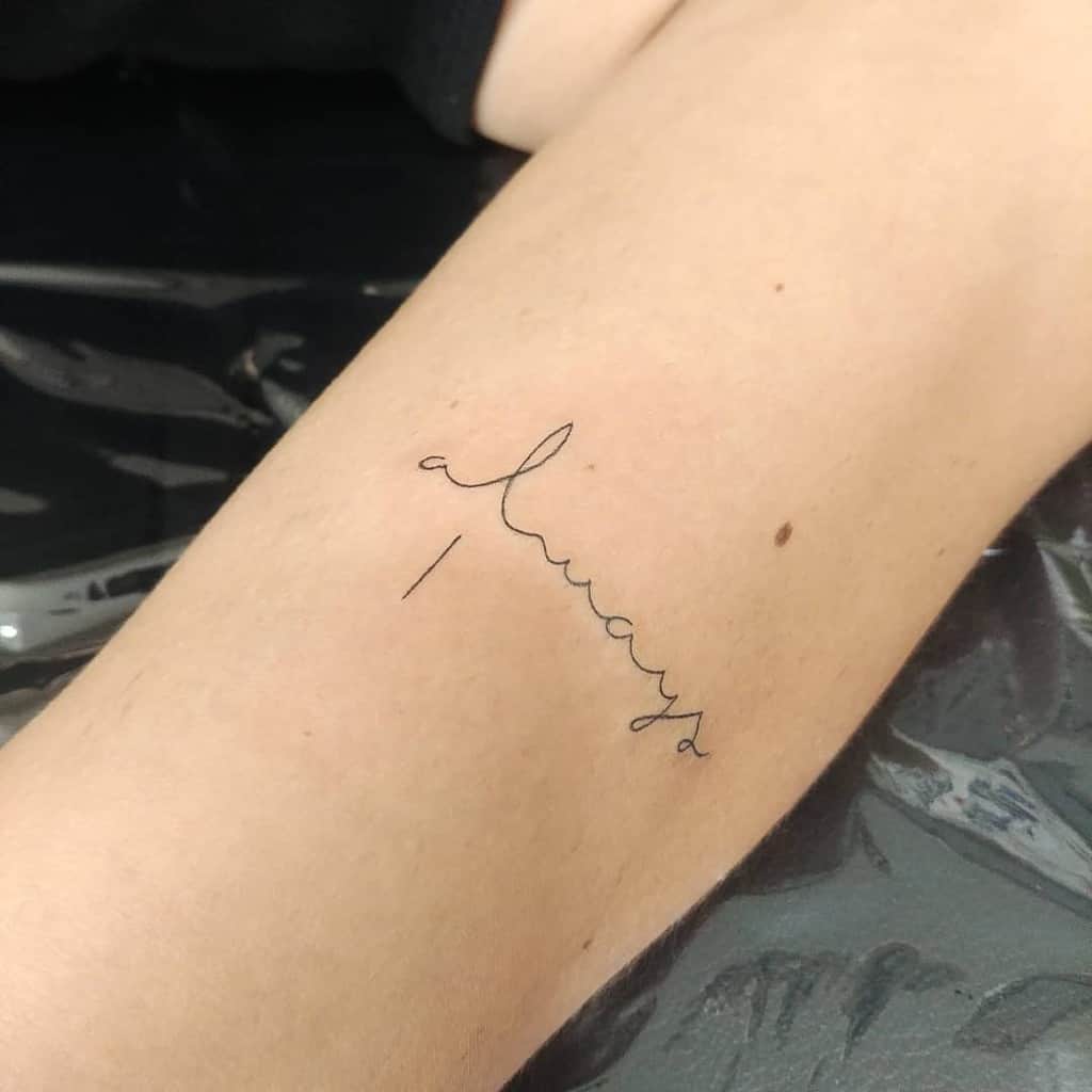 Minimalist tattoo with the word "always" in cursive on forearm
