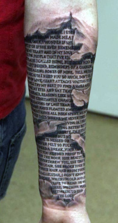 Forearm tattoo with Bible text and a realistic tear effect