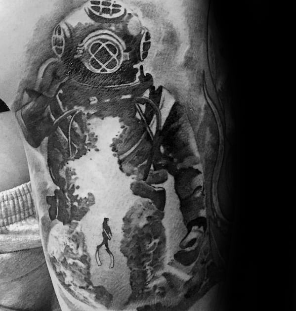 Black and grey tattoo of a vintage deep-sea diver suit with a silhouette of a modern diver exploring underwater within the suit's form.
