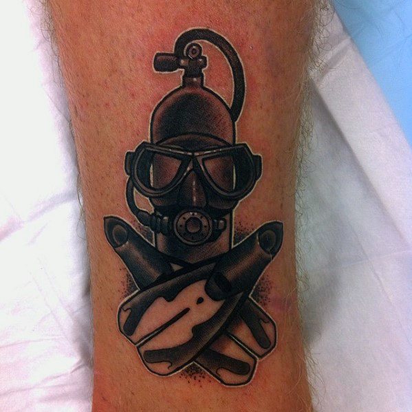 Bold black and grey tattoo of scuba diving gear featuring a tank, mask, and crossed fins with subtle shading.