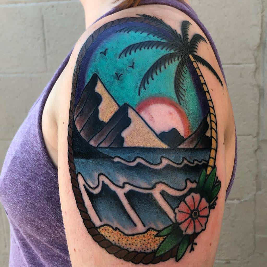 Vibrant tropical tattoo featuring ocean waves, mountains, a sunset, a palm tree, and a rope border with floral details