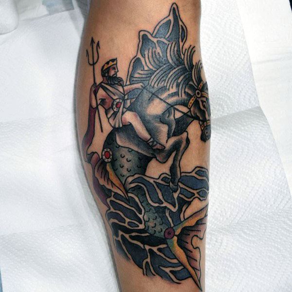 Neo-traditional tattoo of Poseidon riding a seahorse on leg, featuring bold outlines, rich shading, and dynamic oceanic details for a powerful design.