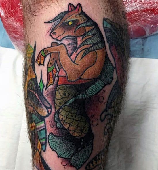 Neo-traditional hippocampus tattoo on leg, featuring bold outlines, vibrant colors, and a mythical half-horse, half-sea creature design.
