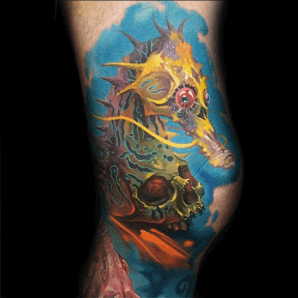 Vibrant surreal seahorse tattoo on leg, featuring bold colors, intricate textures, and a mix of organic and fantasy elements for a striking design.