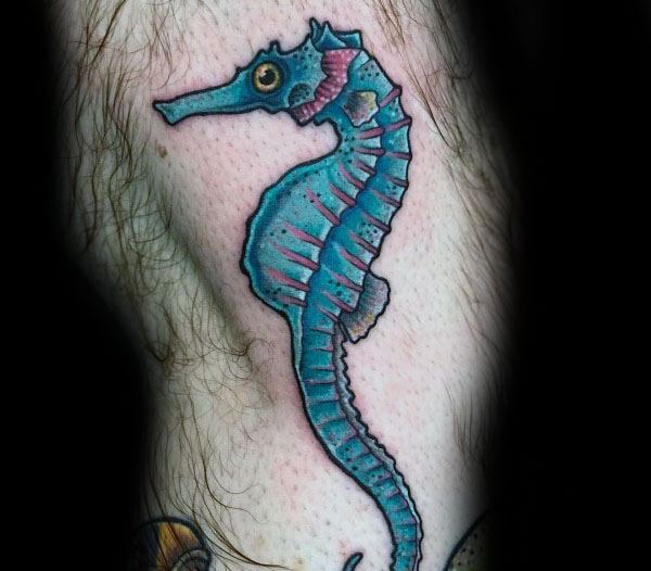 Neo-traditional seahorse tattoo on leg, featuring bold outlines, vibrant blue tones, and subtle shading for a classic yet colorful marine design.