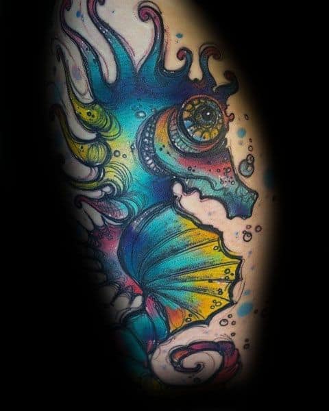 Vibrant fantasy-style seahorse tattoo on arm, featuring bold colors, intricate details, and a surreal aquatic design with glowing effects.
