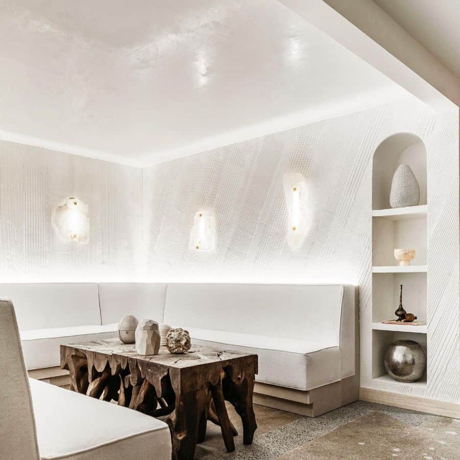 Rustic white living room with built-in seating and a natural wood coffee table.