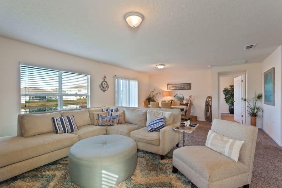 sectional sofa family room white walls ottoman 