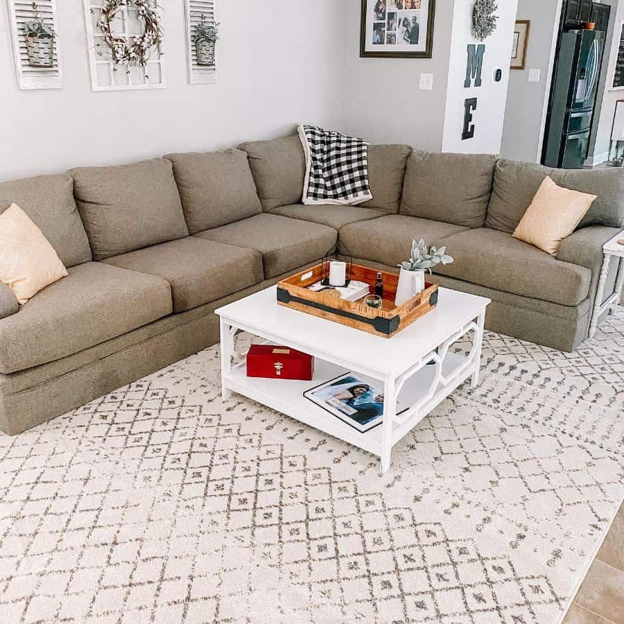 farmhouse style living room gray sectional sofa white living room table wall art