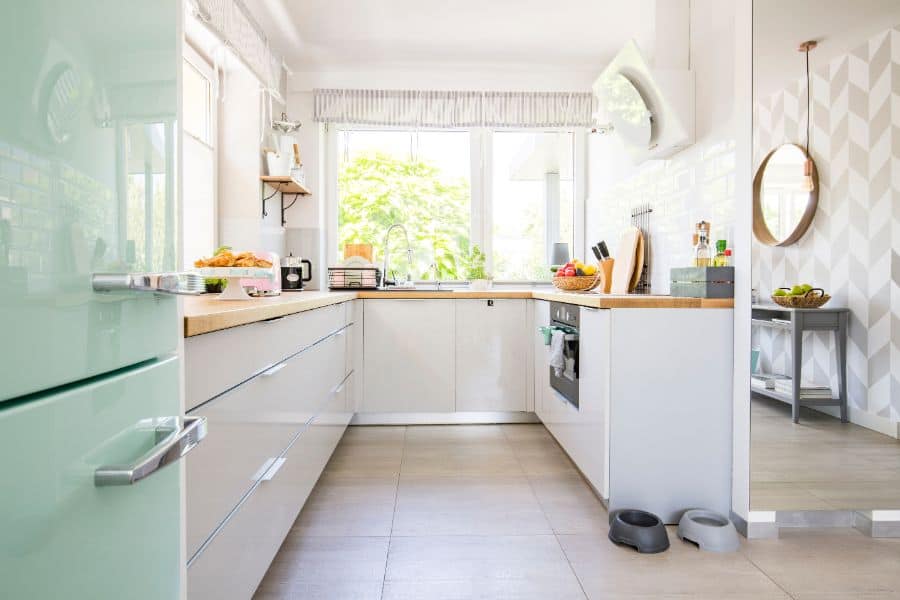 white open kitchen with pale green fridge